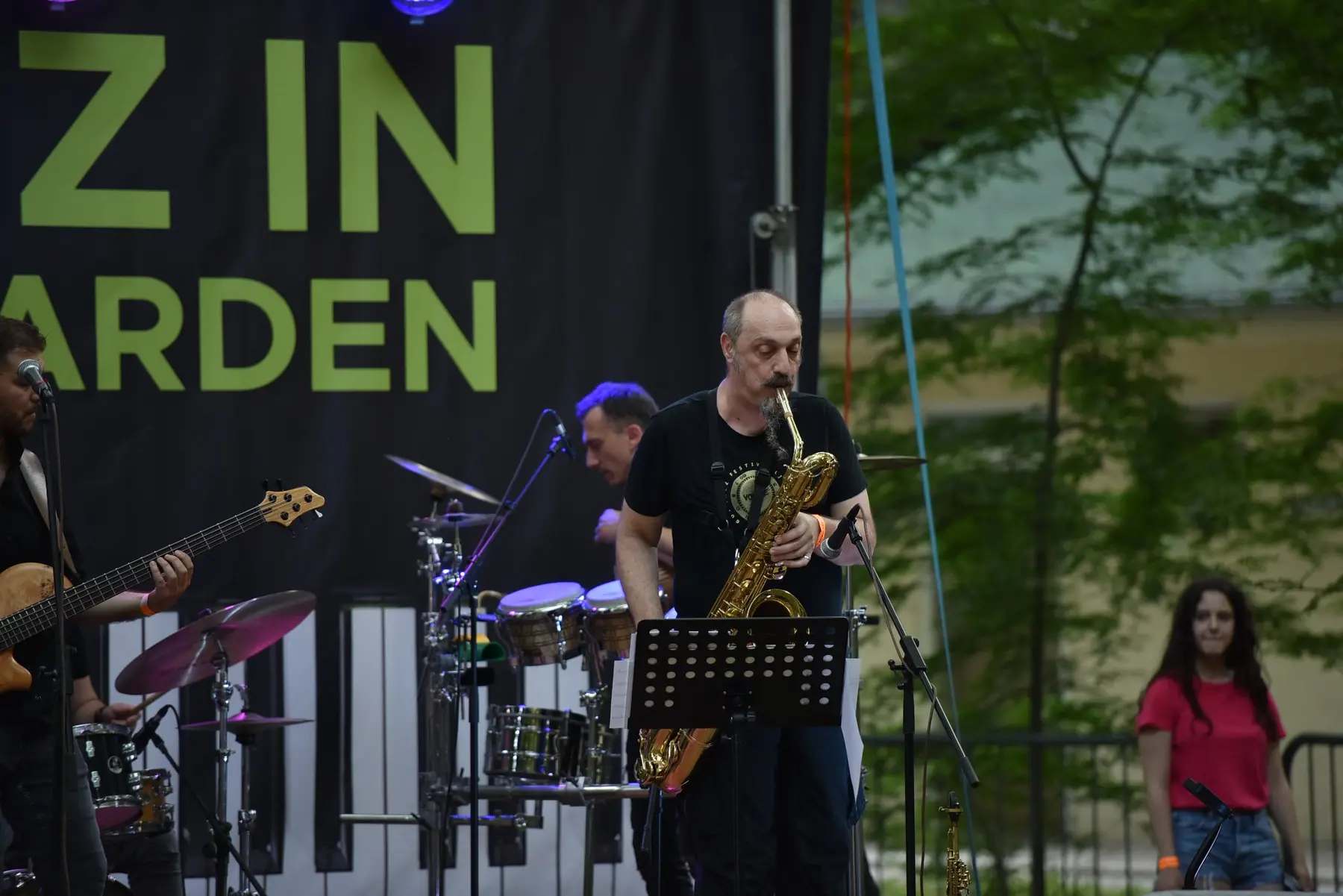 Saxophonist performing outdoors with Bosque Sound Community