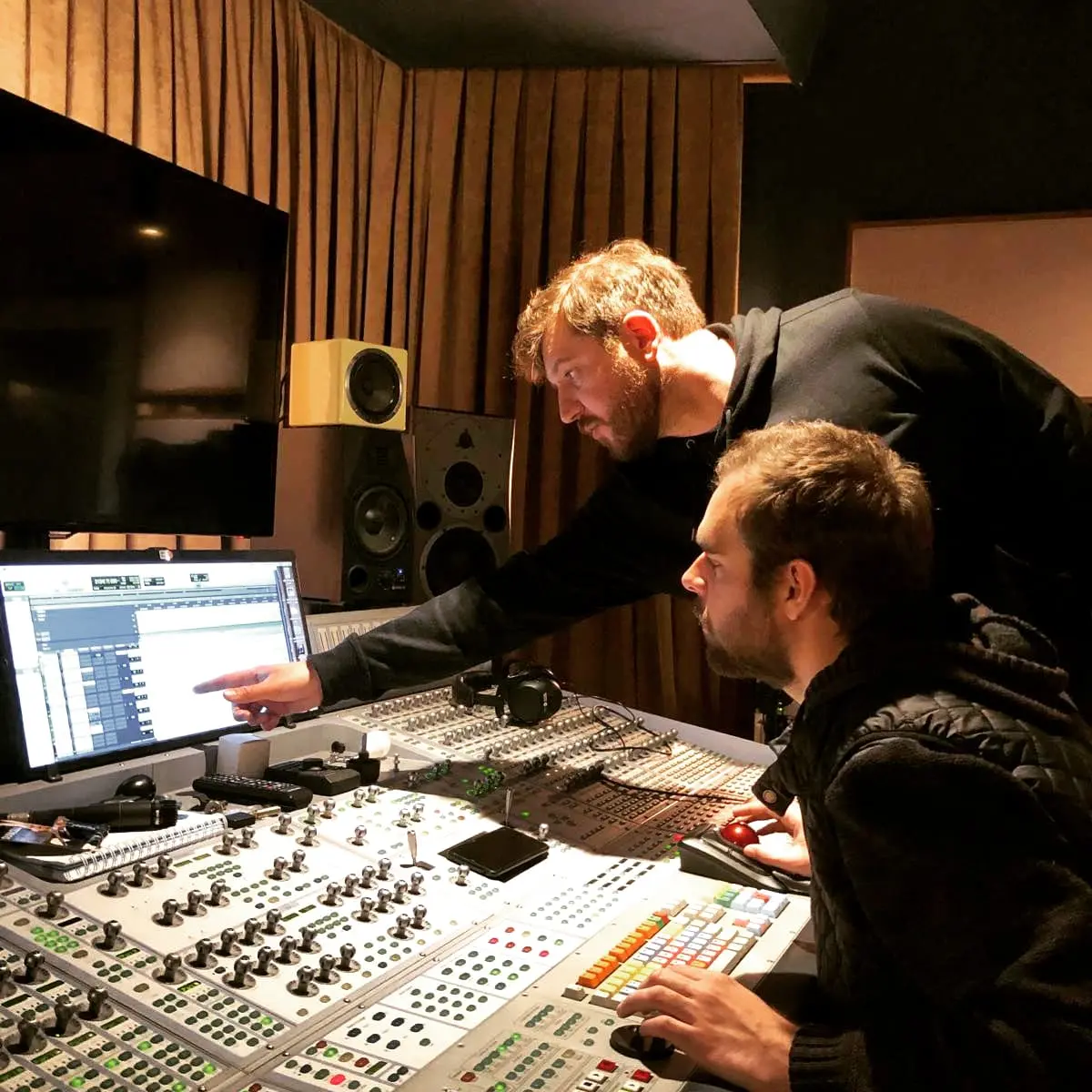 Recording engineers working at the studio console
